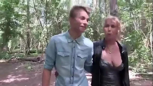 Young guy fucks an adult lady with beautiful boobs right in the forest